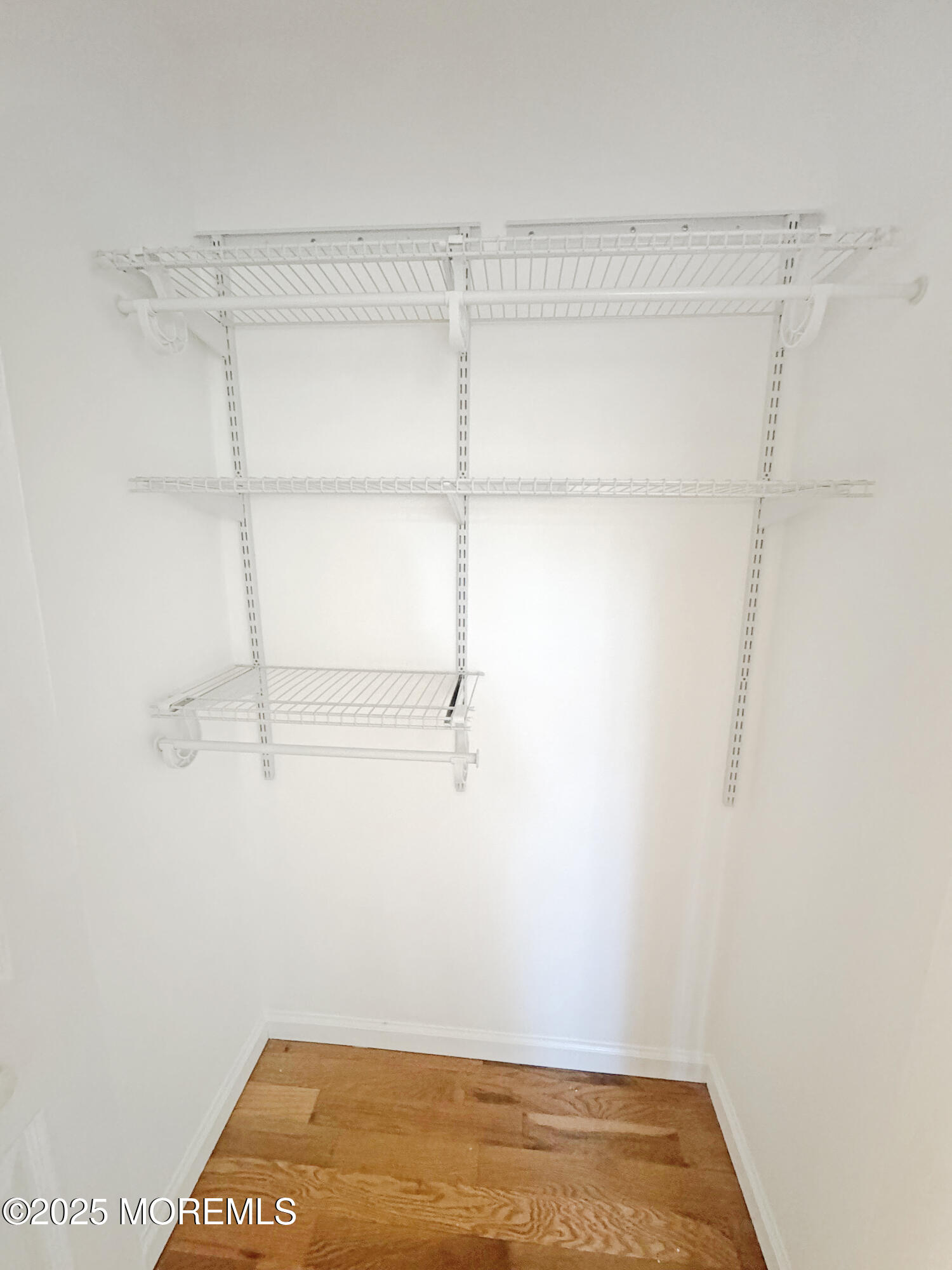 577 Windflower Court Morganville, NJ 07751 - Photo 14 of 27 a view of a room with racks on the wall