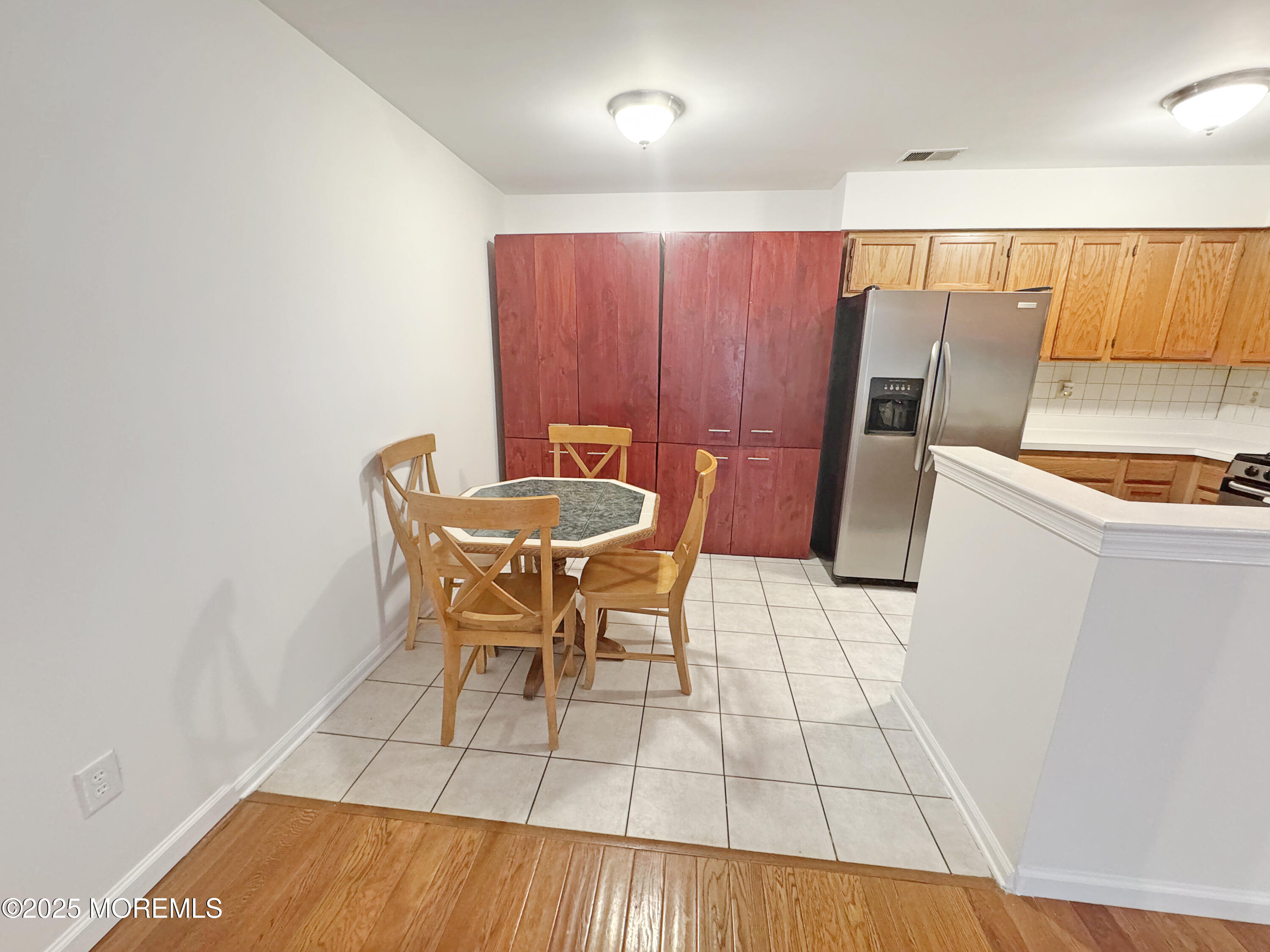 577 Windflower Court Morganville, NJ 07751 - Photo 8 of 27 a dining room with furniture and wooden floor