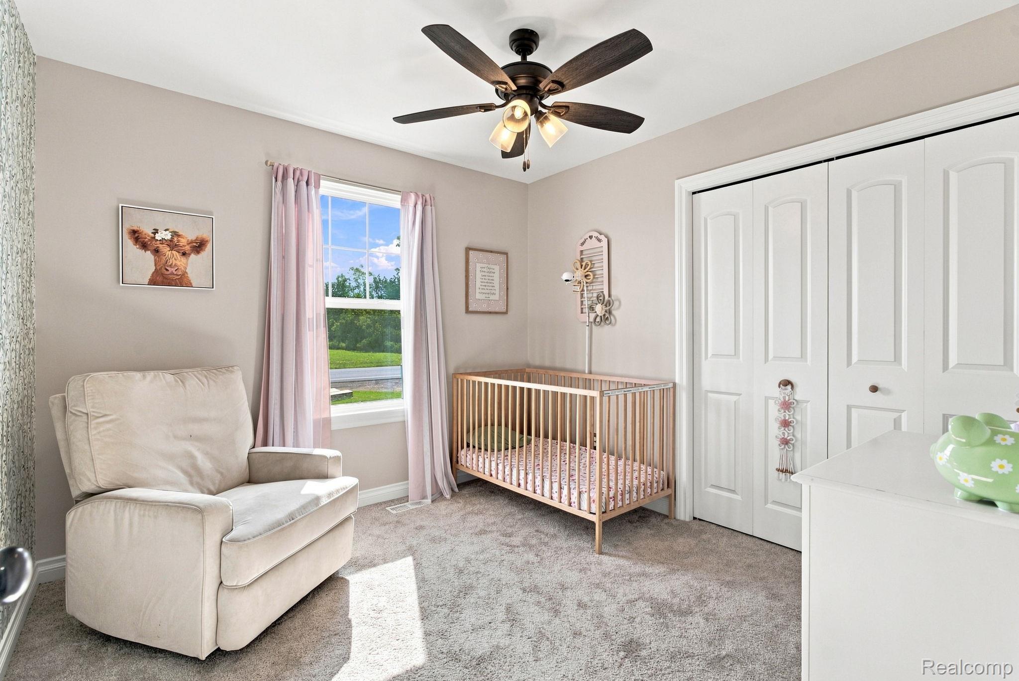 629 Range Road Smiths Creek, MI 48074 - Photo 26 of 36 Wall-to-wall carpeting, a window with natural light, a ceiling fan with integrated lighting, and white bi-fold closet doors