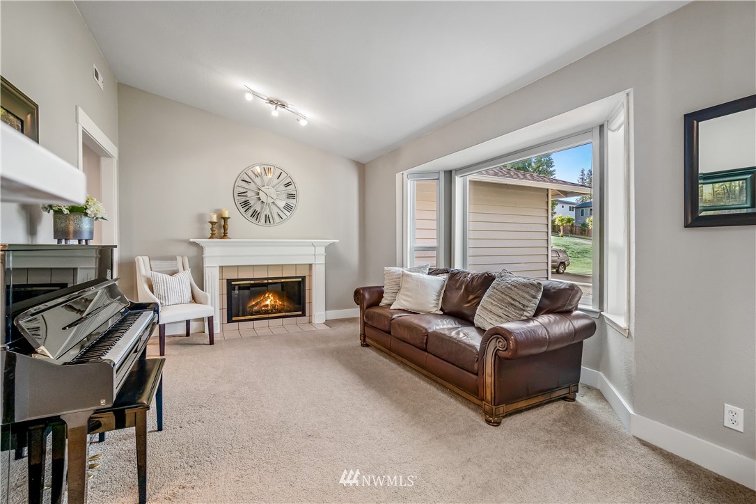 23709 Meridian Avenue South Bothell, WA 98021 - Photo 14 of 35 a living room with furniture and a fireplace