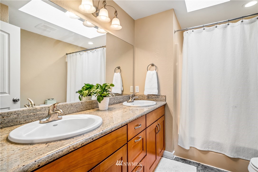 23709 Meridian Avenue South Bothell, WA 98021 - Photo 22 of 35 a bathroom with a double vanity sink and a mirror