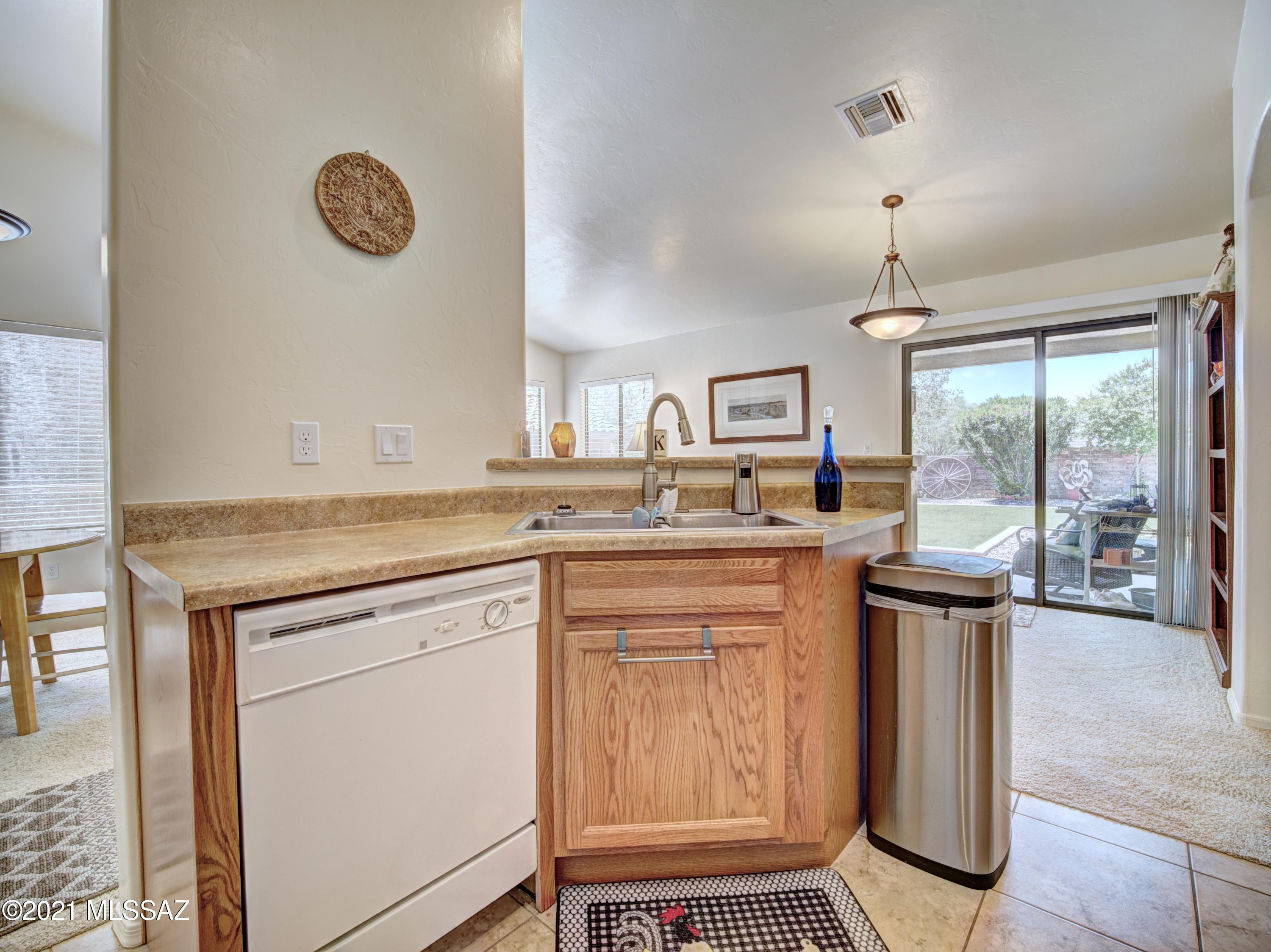 434 Colorado Court Rio Rico, AZ 85648 - Photo 16 of 29 a kitchen with stainless steel appliances granite countertop a stove a sink and a refrigerator