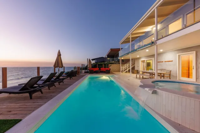 a swimming pool with outdoor seating and yard