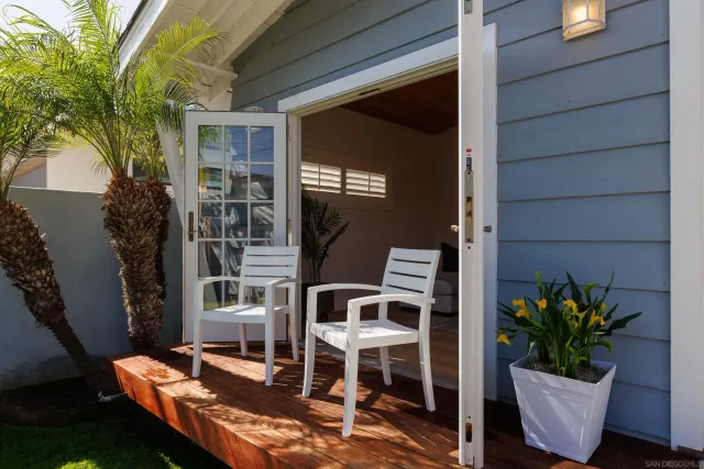 a view of a backyard with table and chairs and potted plants