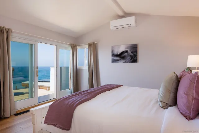 a bedroom with a bed and a painting on the wall