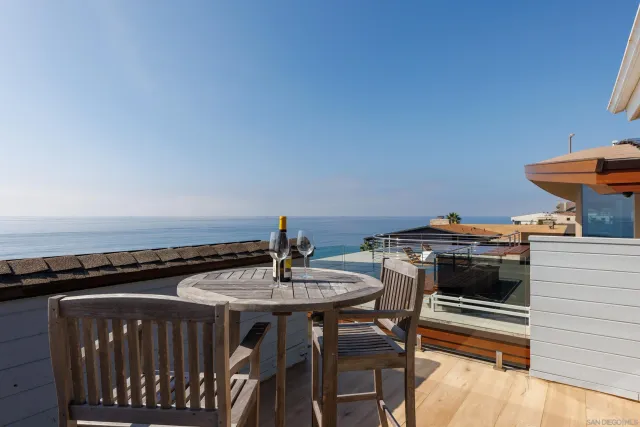 a roof deck with a table and chairs
