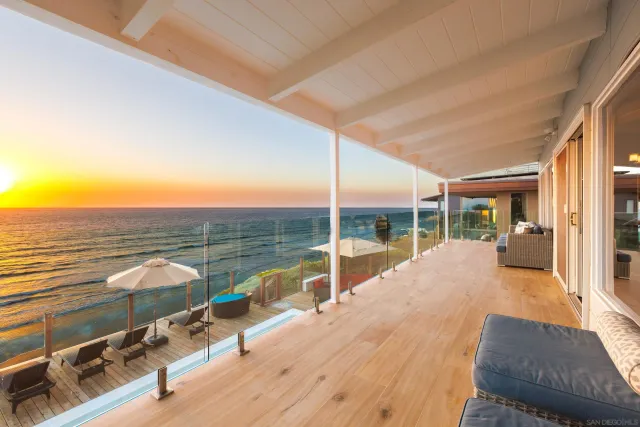 a view of a balcony with table and chairs and wooden floor