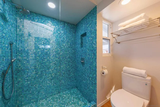 a bedroom with two beds and a large window