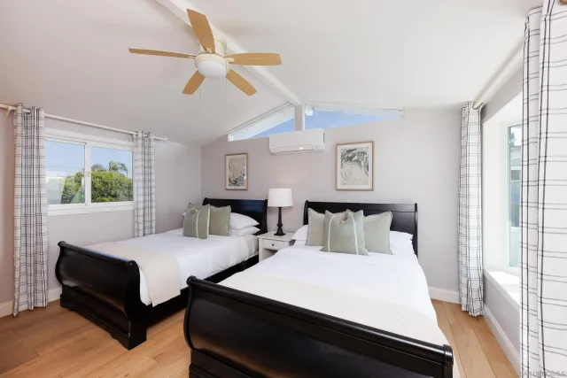 a bedroom with bed and a large window