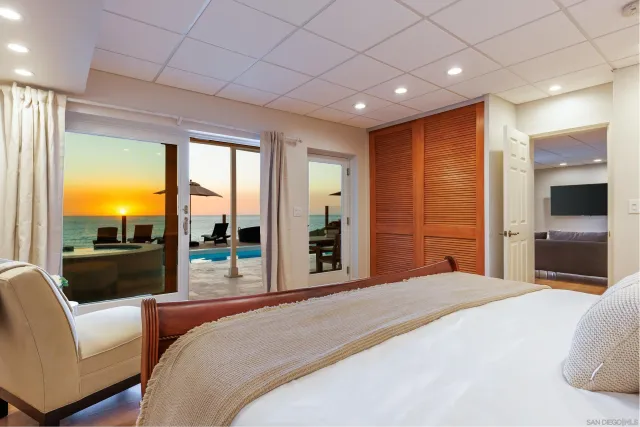 a spacious bedroom with a bed a couch and cabinet