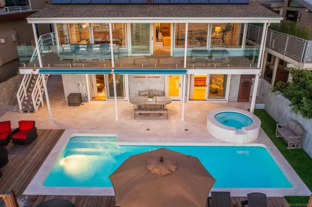 a backyard of a house with outdoor seating