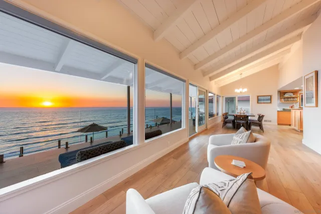 a living room with furniture floor to ceiling windows and view of living room