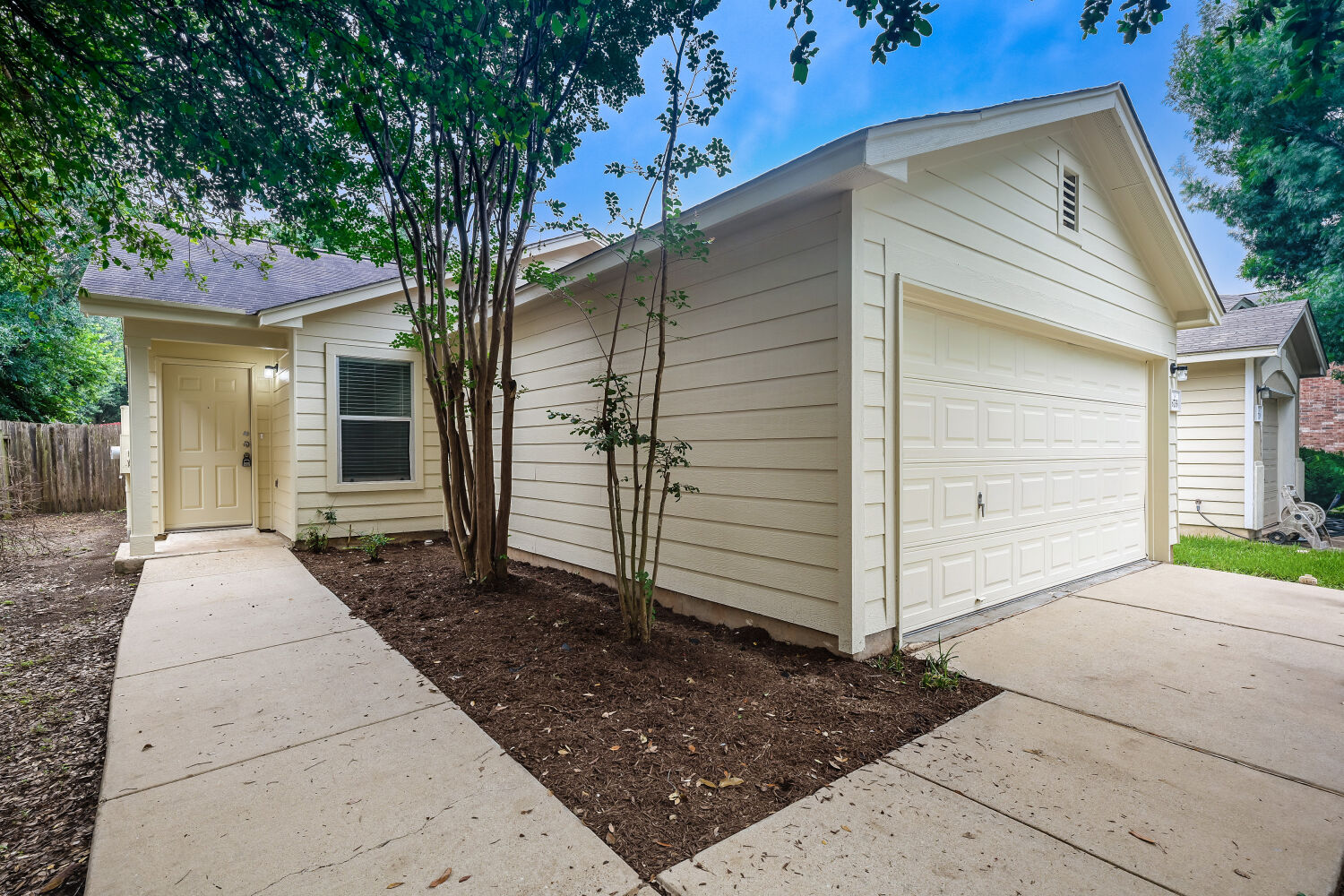 6733 Doyal Drive Austin, TX 78747 - Photo 3 of 28 A well-maintained facade features a practical attached garage and a welcoming walkway.