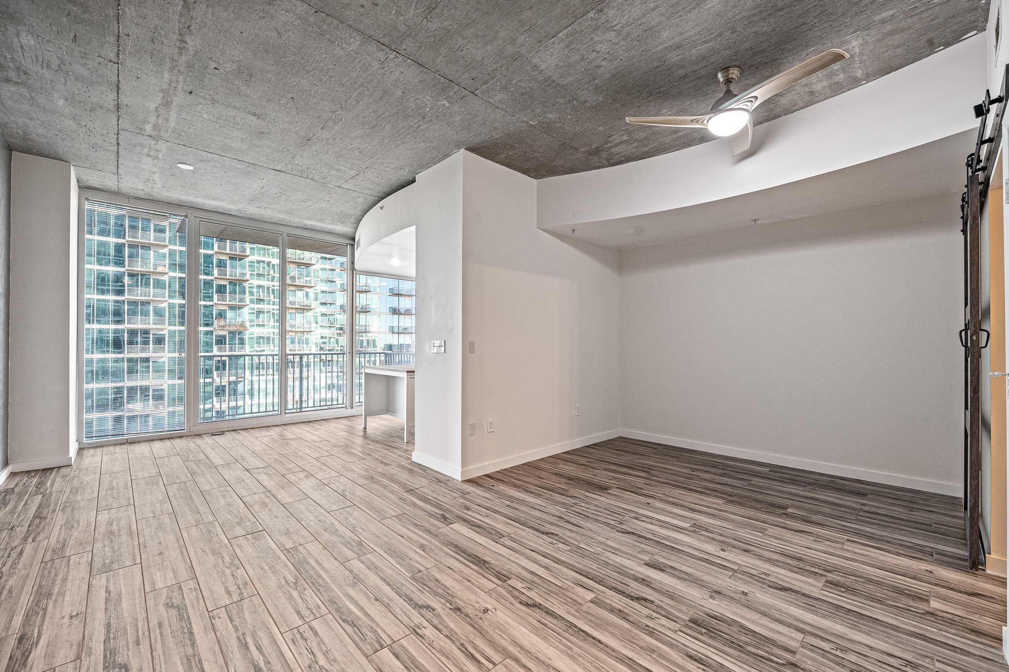 5925 Almeda Road, Unit 11406 Houston, TX 77004 - Photo 5 of 26 a view of an empty room with wooden floor and a window