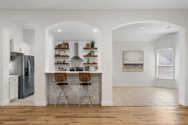 a view of kitchen with furniture and refrigerator