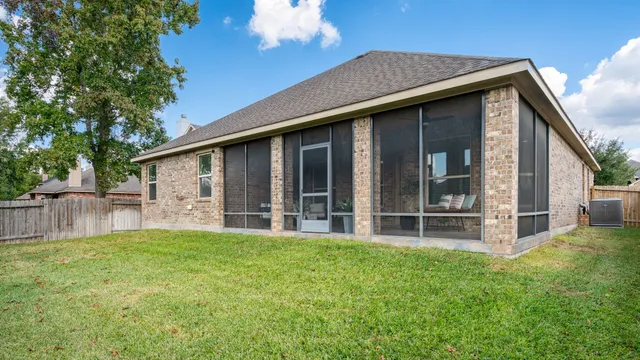a view of a house with a yard and sitting area