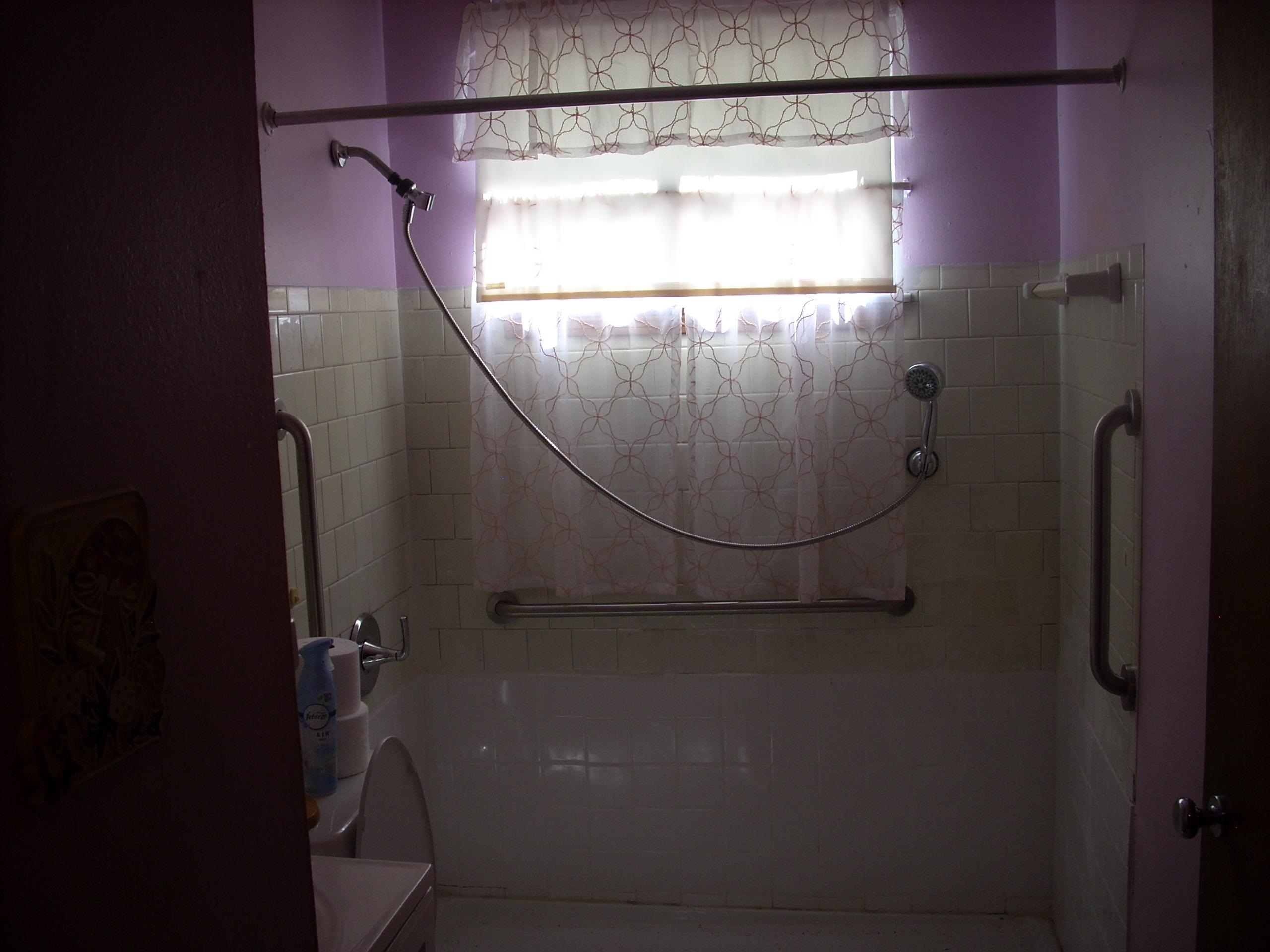 4282 Westmont Road Memphis, TN 38109 - Photo 10 of 15 Shower with white tiled surround and integrated grab bars