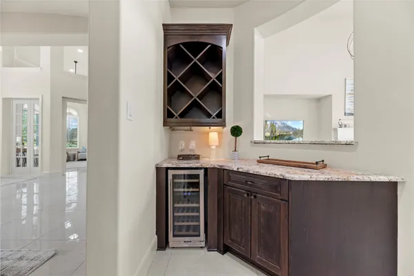 a kitchen with stainless steel appliances granite countertop a sink and a stove next to a window