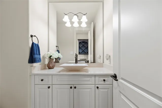 a bathroom with a sink vanity and a mirror
