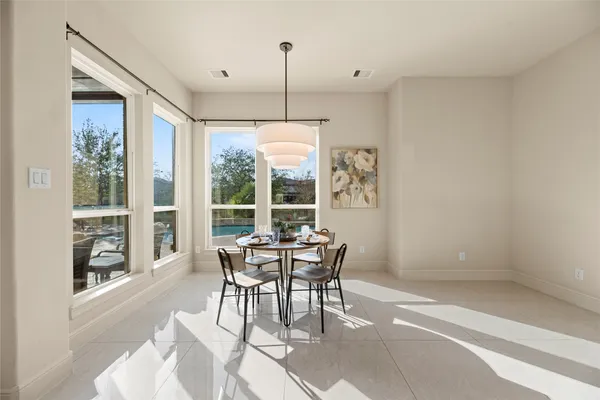 a dining room with furniture and window