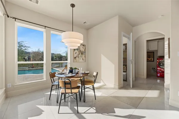 a dining room with furniture a chandelier and a rug
