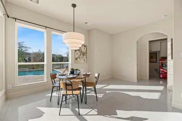 a dining room with furniture a chandelier and a rug