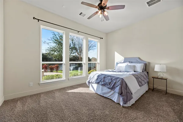 a spacious bedroom with a bed and a large window
