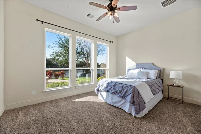 a spacious bedroom with a bed and a large window