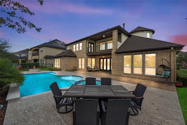 a view of a house with backyard and sitting area