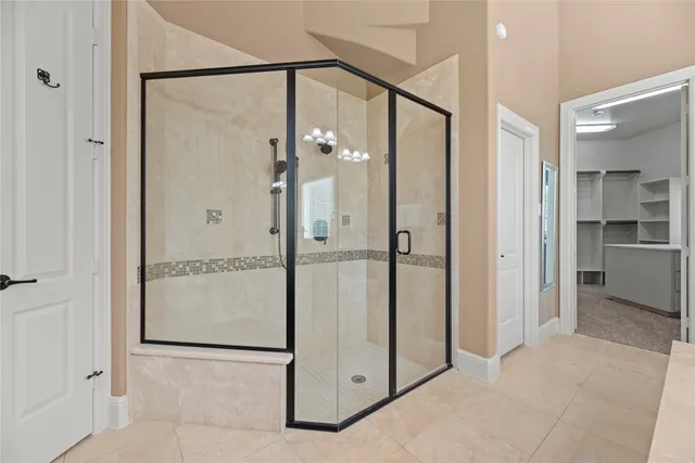 a bathroom with a glass shower door and a sink