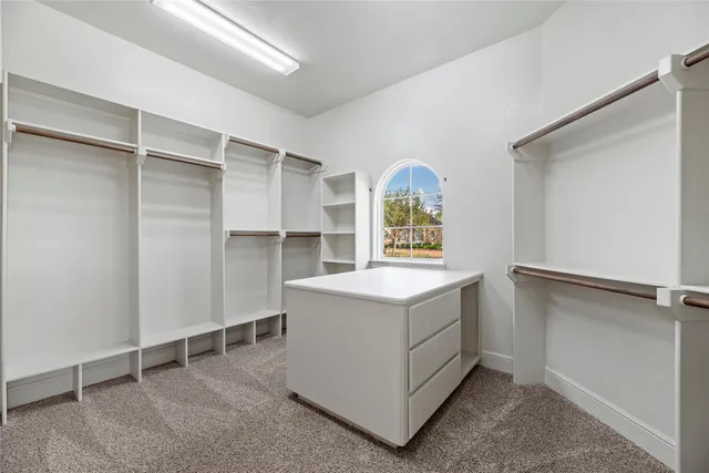 a utility room with cabinets washer and dryer