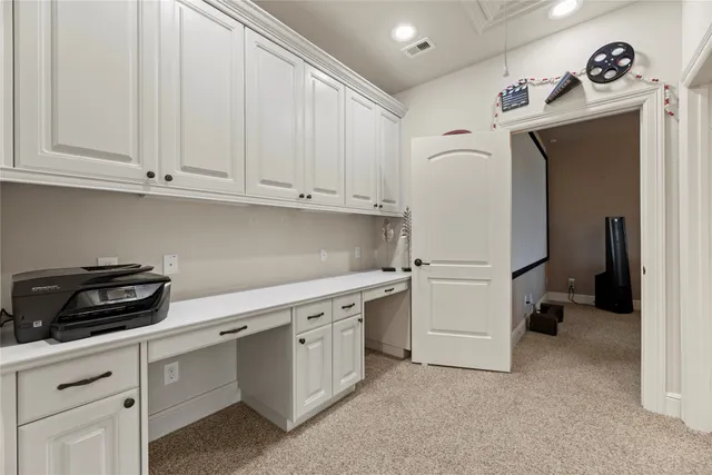 a kitchen with white cabinets and white appliances