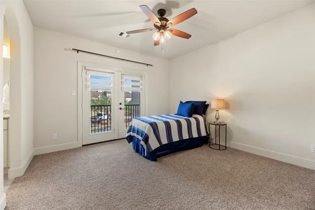 a spacious bedroom with a bed and a chandelier