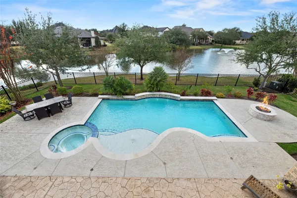 swimming pool view with a seating space