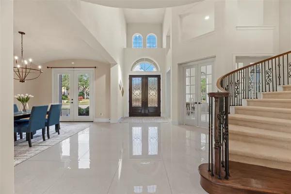 a view of a hallway with wooden floor and furniture