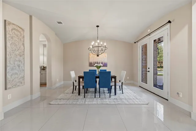 a view of a dining room with furniture and chandelier