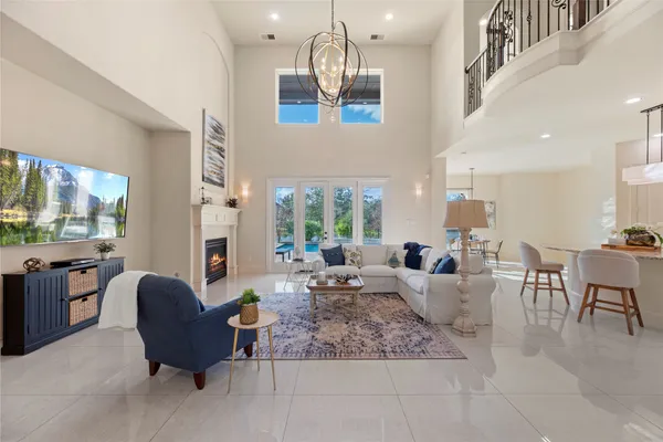 a living room with fireplace furniture and a large window