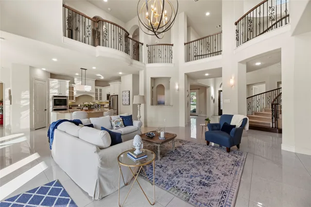 a living room with furniture and a chandelier