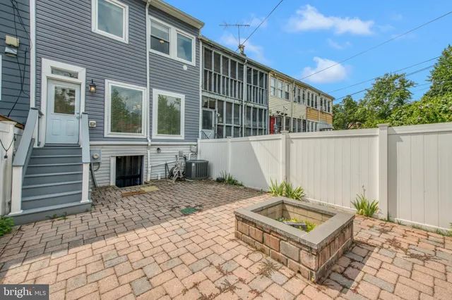 a backyard of a house with table and chairs