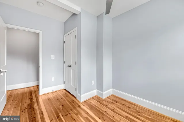 a view of room with wooden floor