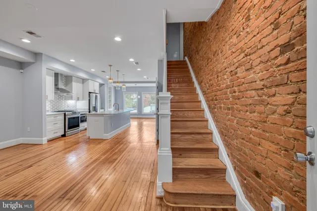 a view of entryway and hall with wooden floor