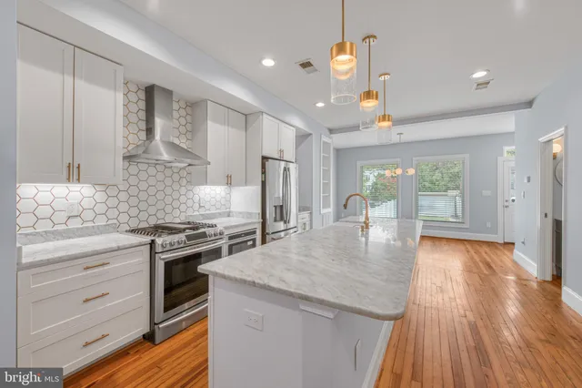 a kitchen with stainless steel appliances granite countertop a stove and refrigerator