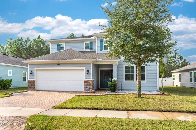 a front view of a house with a yard and garage