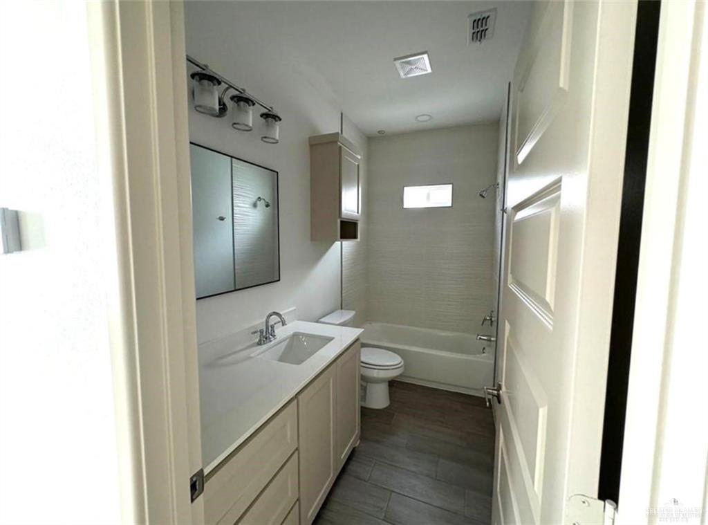 7710 North 58th Street, Unit 2 Mission, TX 78573 - Photo 11 of 13 a bathroom with a sink a toilet and shower
