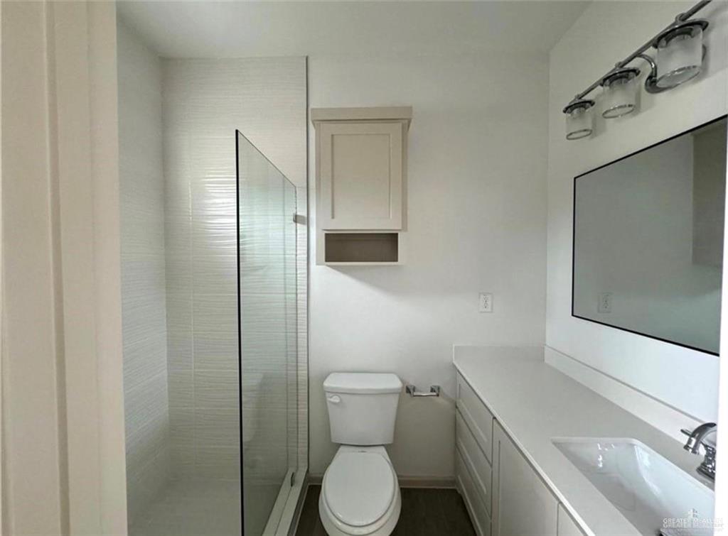7710 North 58th Street, Unit 2 Mission, TX 78573 - Photo 7 of 13 a white toilet sitting next to a bathroom sink
