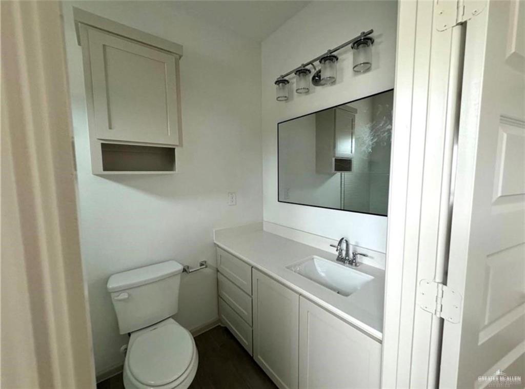 7710 North 58th Street, Unit 2 Mission, TX 78573 - Photo 8 of 13 a bathroom with a toilet sink and mirror