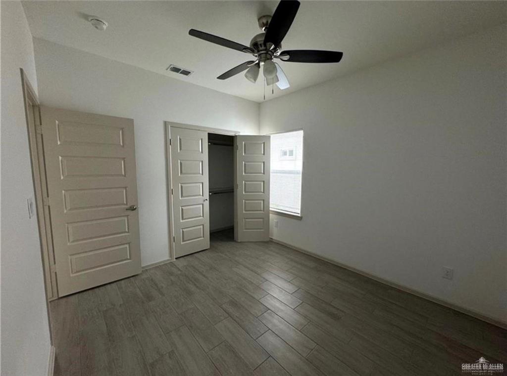 7710 North 58th Street, Unit 2 Mission, TX 78573 - Photo 10 of 13 an empty room with closet and windows