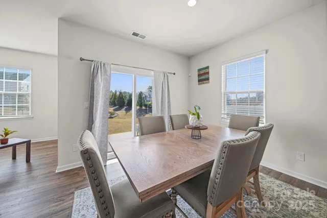 a kitchen with stainless steel appliances granite countertop a refrigerator and white cabinets