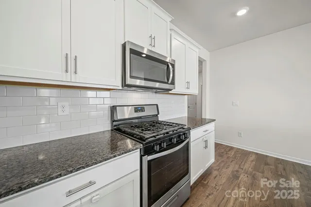 a kitchen with a stove and cabinets