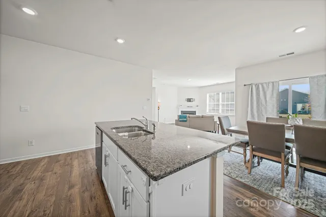 a kitchen with granite countertop wooden cabinets and stainless steel appliances